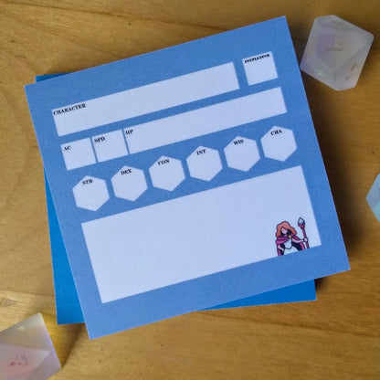 Blue character sheet with dice on a wooden surface