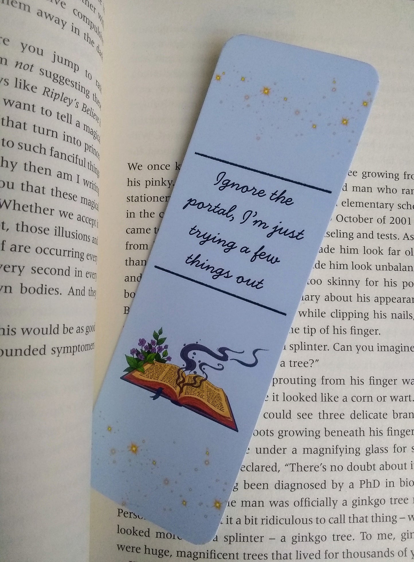 Bookmark with text 'Ignore the portal, I'm just trying a few things out' and illustration of a spell book on an open book