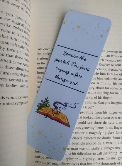 Bookmark with text 'Ignore the portal, I'm just trying a few things out' and illustration of a spell book on an open book