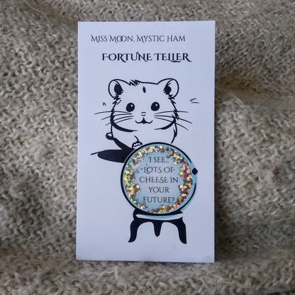 Fortune teller card with a hamster and crystal ball on a textured surface