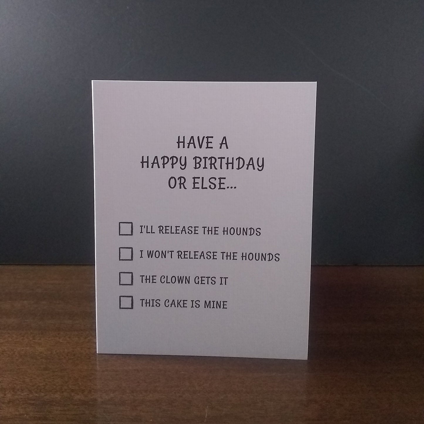 Birthday card with humorous text and checkboxes on a dark background