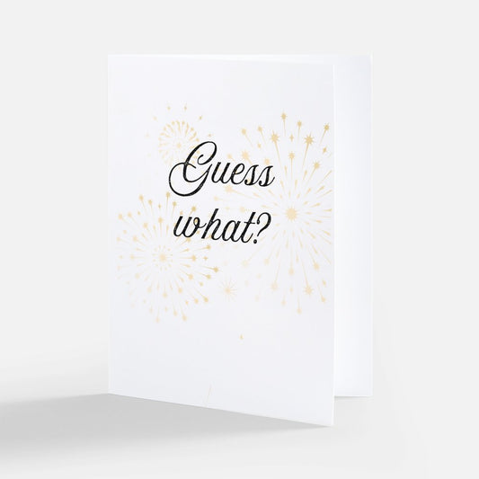 White card with the text 'Guess what?' on the front on a white background